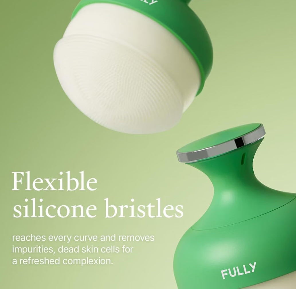 A green and white facial cleansing brush head floating above a matching green device base with a silver rim, on a soft green background. White text reads 'Flexible silicone bristles' and 'reaches every curve and removes impurities, dead skin cells for a refreshed complexion.